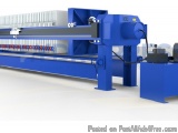 The image shows a blue-colored industrial machine, which appears to be a type of sheet metal cutting machine. It has a long,...