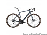 The image is of a bicycle, specifically a Cannondale SuperX 2.0. It is a road bike with a grey frame and black saddle. The bi...
