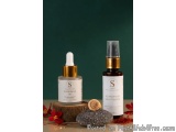 The image shows two bottles of skincare products, one with a dropper and the other with a spray nozzle. The bottles are place...