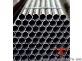 The image shows a stack of multiple metal pipes or tubes. The pipes are arranged in a horizontal manner and are of different...