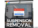 The image shows a laptop screen with the Google You Business app open on it. The app has a pop-up window with the text "Suspe...