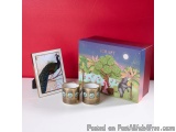 The image shows a gift set with a blue box and two mugs. The box has an illustration of a jungle scene with trees, plants, an...