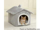 The image shows a small, grey cat house with a sloping roof. The house is made of a soft, plush material and has a small open...