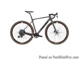 The image is of a mountain bike. The bike is grey in color with black accents. It has a black saddle and handlebars. The fram...