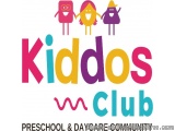 The image is a logo for Kiddos Club, a preschool and daycare community. The logo is written in a colorful, sans-serif font wi...