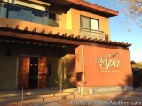 The image shows the exterior of a building with a sign that reads "The Spa at Redwood Ridge". The building is a two-story str...