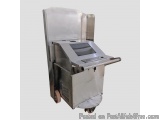 The image shows a large industrial machine with a metallic body and a flat top. The machine is made of stainless steel and ha...