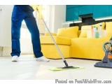 The image shows a person cleaning the floor with a mop. The person is wearing blue jeans and white sneakers. The mop is on a...