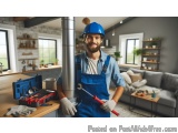 In this image, we can see a man wearing a blue hard hat and overalls, holding a wrench in his right hand. He is standing in a...