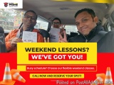 The image shows three people sitting in the back seat of a car, smiling and holding up their tickets. They appear to be happy...
