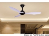 The image shows a modern ceiling fan in a room. The fan has a black base and white blades that are slightly curved. The blade...