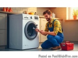 In this image, we can see a young man kneeling on the floor in front of a washing machine in a kitchen. He is wearing a yello...