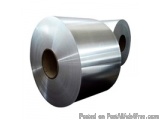 The image shows a roll of aluminum foil. The roll is cylindrical in shape and appears to be made of a shiny, metallic materia...
