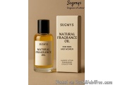 The image shows a bottle of Sugmy's Natural Fragrance Oil for men and women. The bottle is made of glass and has a black cap....