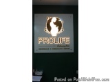 The image is a photograph of a sign for a clinic called Prolife Obstetrics & Gynecology Center. The sign is rectangular in sh...