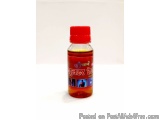 The image is of a small glass bottle with a red cap. The bottle is filled with a yellowish-orange liquid. The label on the bo...
