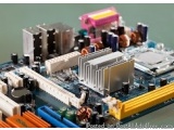 The image shows a close-up of a computer motherboard with various electronic components. The motherboard is blue in color and...