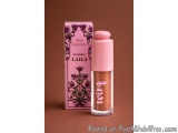 The image shows a bottle of wing cosmetics eyeshadow in the shade Laila. The bottle is cylindrical in shape with a pink cap a...