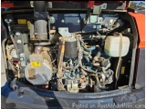 The image shows the engine compartment of a vehicle, specifically the engine bay. The engine is located in the back of the ve...