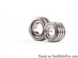 The image shows a pair of cylindrical bearings. They are made of metal and have a shiny, metallic finish. The bearings are ar...