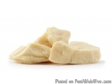 The image shows a pile of small, triangular-shaped pieces of cheese. The cheese appears to be a light yellow color and has a...