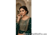 The image is a portrait of a young Indian woman wearing a traditional Indian outfit. She is wearing a green anarkali suit wit...