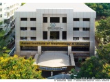 The image shows the exterior of the Asian Institute of Nephrology & Urology building. The building is a modern, two-story str...