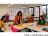The image shows a group of four young people working in a sewing studio. They are sitting around a table with a sewing machin...