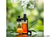 The image shows two glass bottles with black caps, filled with a red liquid. The bottles are placed on a green surface with a...