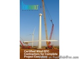 The image shows a construction site with a large crane and a wind turbine. The crane is lifting a large white wind turbine fr...