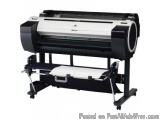 The image shows a large format printer on a stand. The printer is black and white in color and has a sleek and modern design....