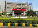 The image shows the entrance of a building with a sign that reads "The Hubble UPS". The building is made of grey concrete and...