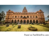 The image is a photograph of a large, ornate building with a dome on top. The building appears to be a palace or a palace, wi...