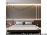 The image shows a modern and luxurious bedroom with a large bed in the center. The bed has a gray headboard and a white mattr...