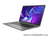 The image shows a laptop computer with a purple and blue abstract design on the screen. The laptop is silver in color and has...