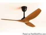 The image shows a ceiling fan with a wooden blade and a black fan blade. The fan has a round base with a small knob in the ce...