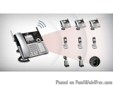 The image shows a black and silver landline phone with a touch screen display. The phone is placed on a white background and...