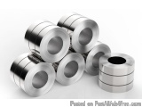 The image shows a group of six rolls of aluminum foil. The rolls are arranged in a pyramid-like formation, with the largest r...