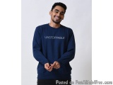 The image shows a young man with a big smile on his face. He is wearing a navy blue sweatshirt with the word "UNSTOPPABLE" wr...