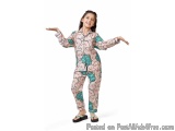The image shows a young girl standing with her arms stretched out to the sides. She is wearing a pink onesie with a colorful...