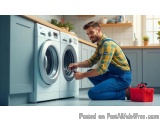 In this image, we can see a young man in a kitchen, kneeling on the floor in front of a washing machine. He is wearing a yell...