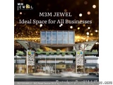 The image is an advertisement for M3M Jewel, an ideal space for all businesses. The advertisement features a modern building...