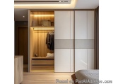 The image shows a modern and minimalist bedroom with a large walk-in closet. The closet has a wooden wardrobe with a sliding...