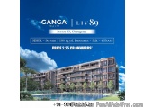 The image is an advertisement for a residential complex called Ganga Realty. The background of the image is a blue sky with w...