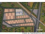 The image is an aerial view of a large building with a checkered pattern on its surface. The building appears to be a shoppin...