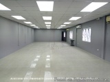 The image shows an empty room with a high ceiling and white walls. The floor is made of light-colored tiles and there are two...