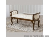 The image shows a wooden bench with a white upholstered seat. The bench has a curved backrest with a tufted design and gold a...