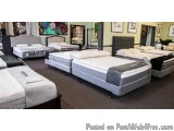 The image shows a large room with multiple beds arranged in it. The beds are of different sizes and styles, with some having...