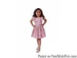 The image is of a young girl, probably around 4-5 years old, standing with her hands on her hips and smiling at the camera. S...