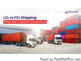 The image shows a group of trucks parked in front of a large warehouse with multiple stacks of colorful shipping containers....